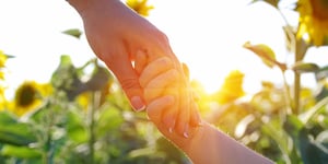 sunflowers_holding-hands_AdobeStock_377856522_copyright-Alekss_1000x500px